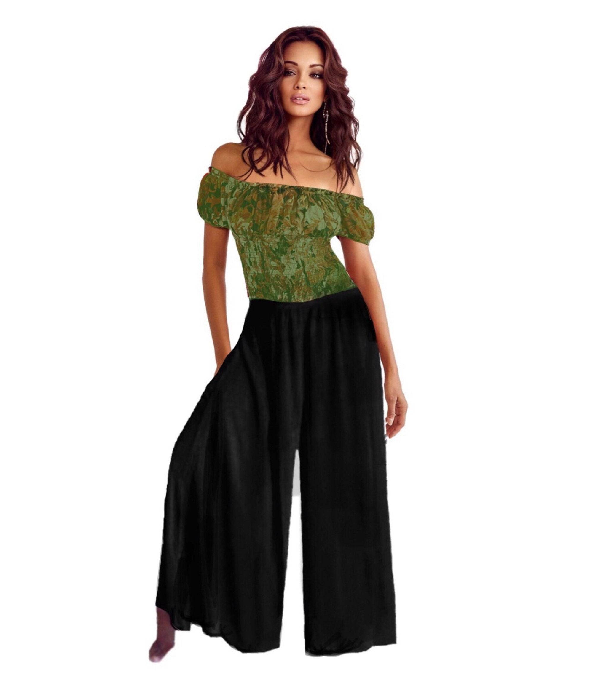 Black split skirt gaucho palazzo pants with a wide-leg silhouette and elastic waist, styled with an off-shoulder green top.