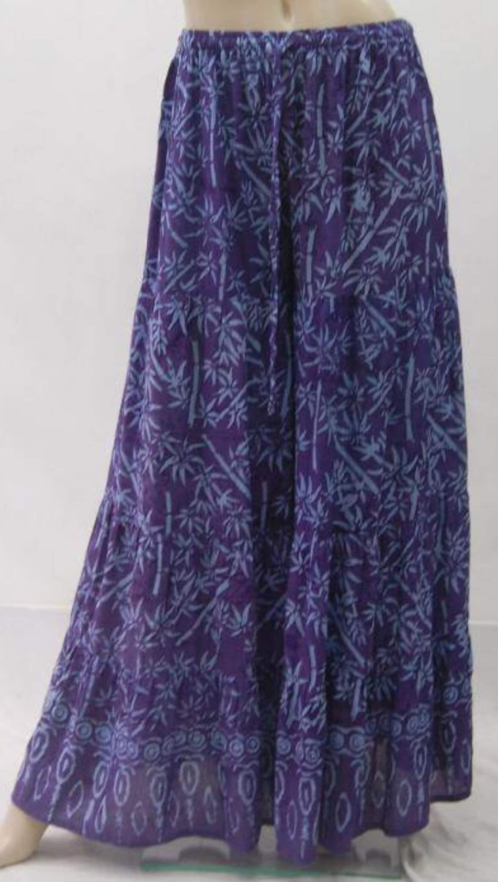 Purple batik print wide leg hippie pants with tiered design. Elastic waist and drawstring provide a relaxed and stylish boho fit.