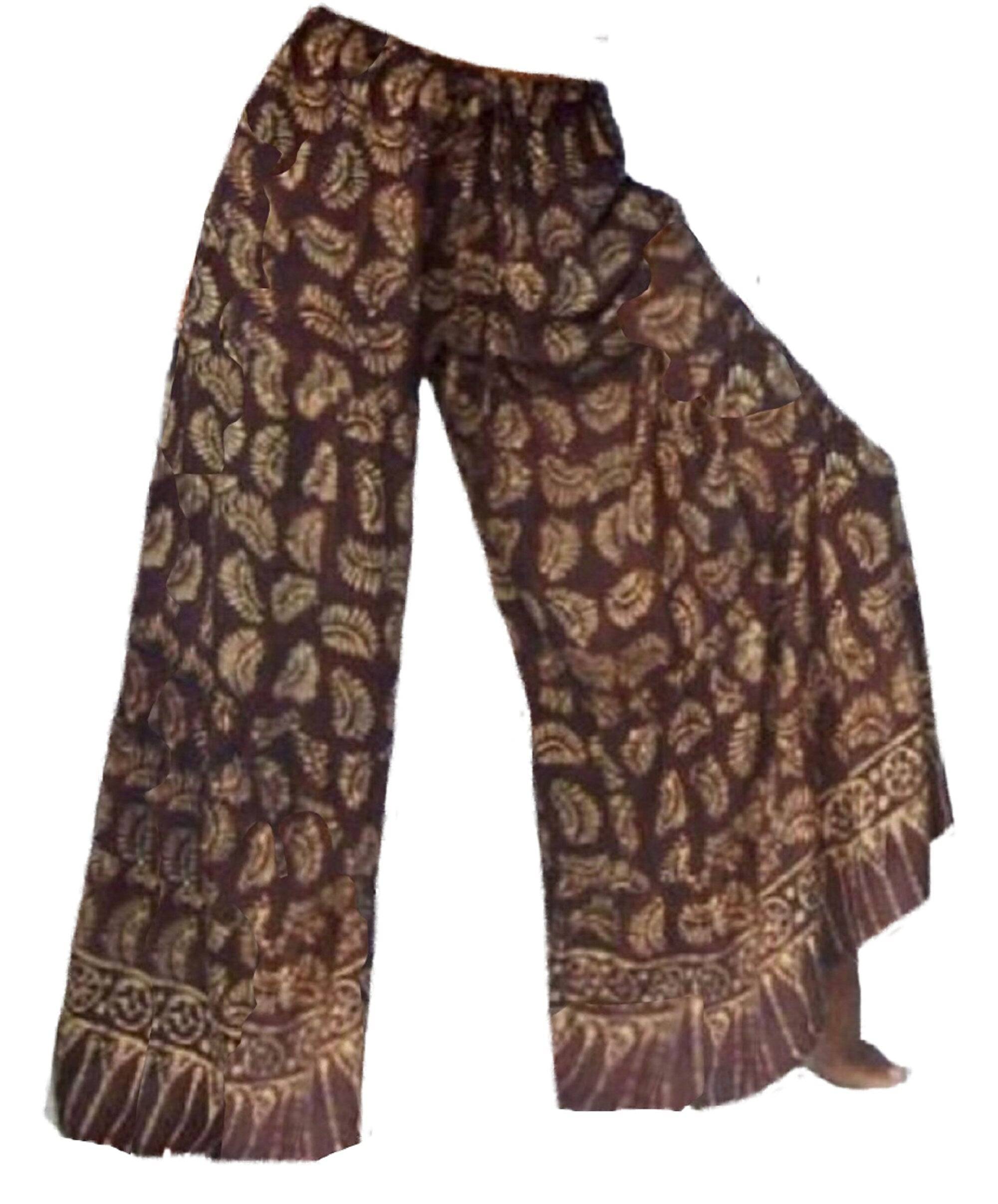 Brown Bali batik print wide leg hippie pants with intricate patterns. Features an elastic waist and drawstring for a comfortable fit.