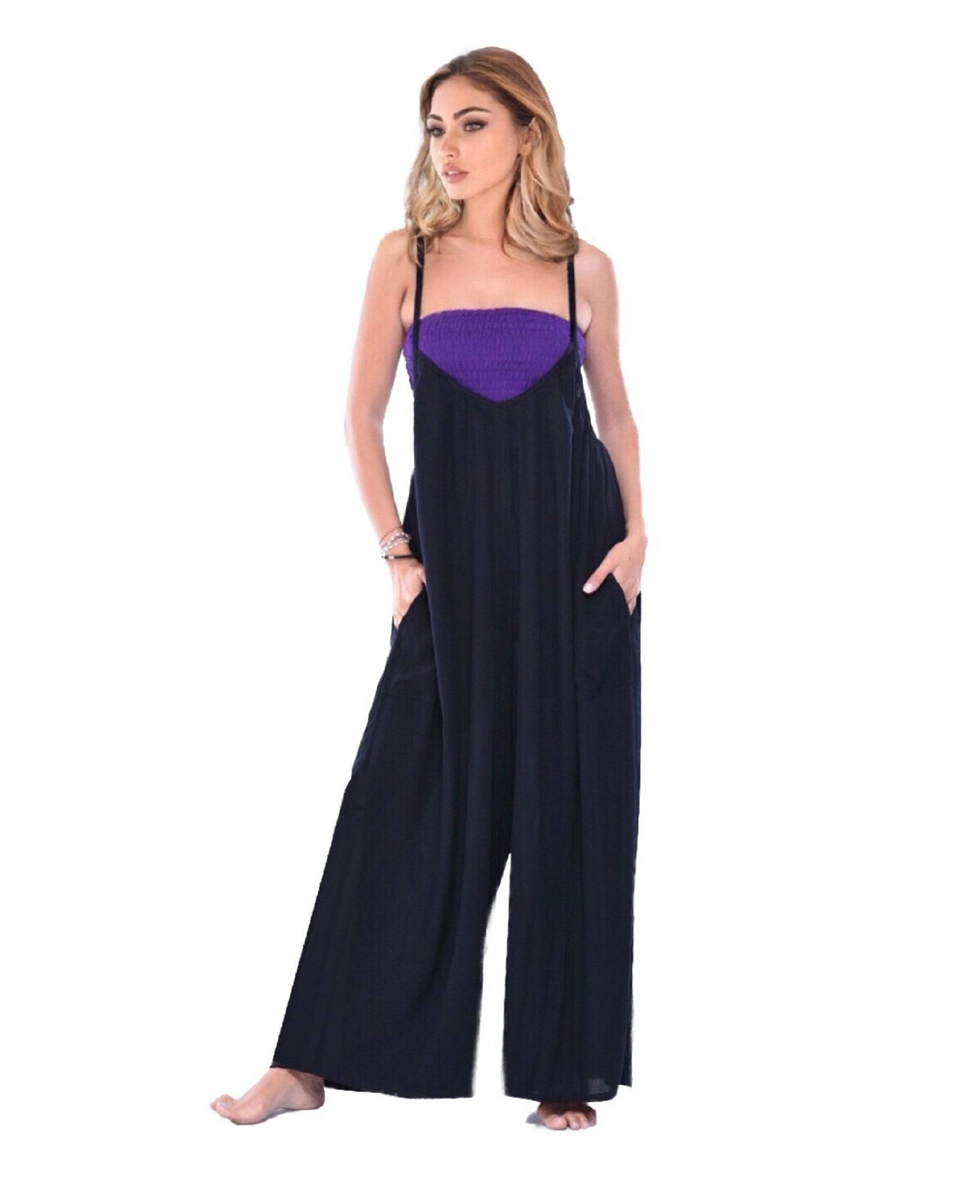 Comfortable black and purple jumpsuit with thin straps and wide-leg fit. Features side pockets for added convenience.