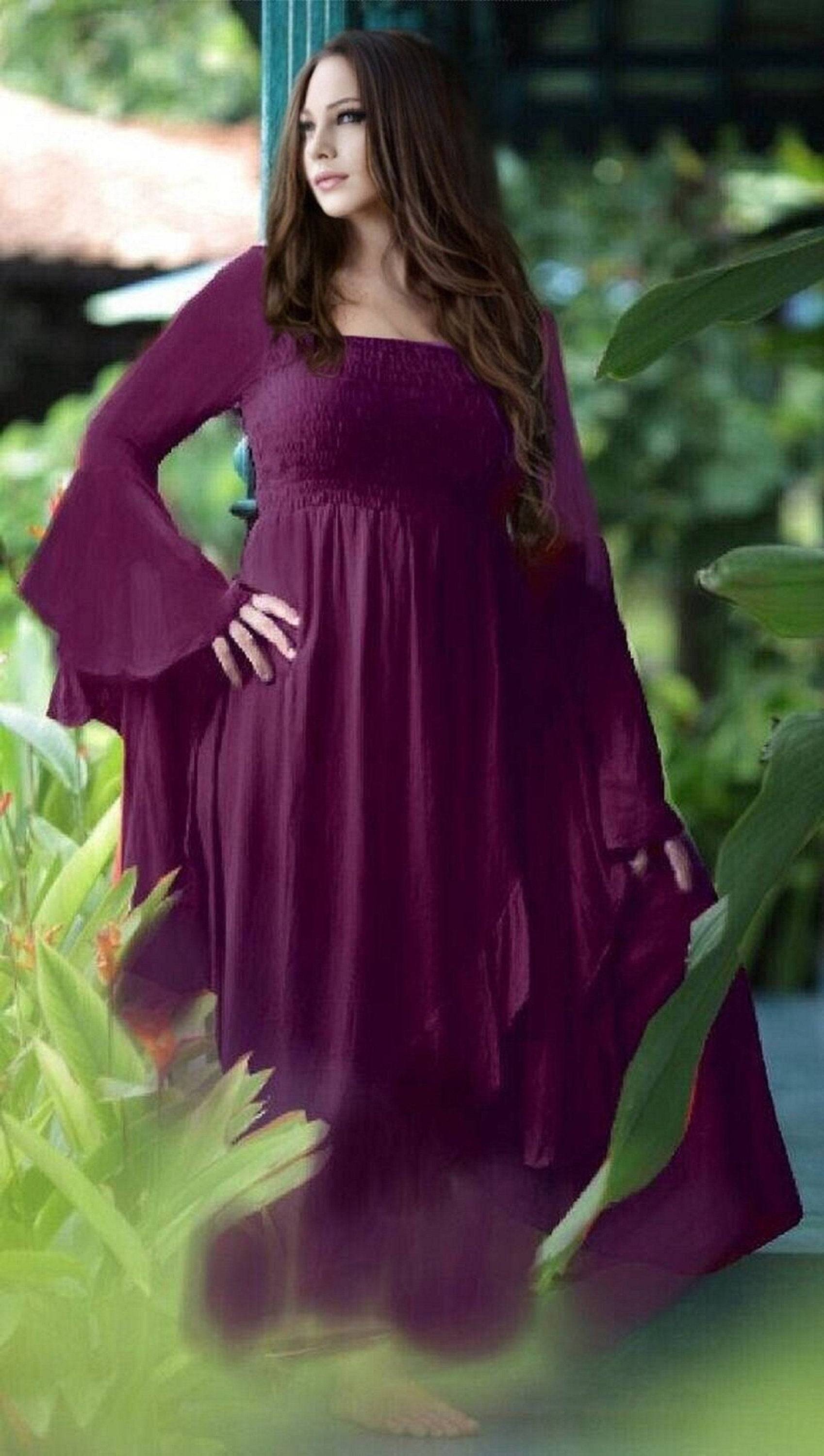 Deep burgundy ruffle wrap maxi dress with waterfall sleeves, designed with a smocked bodice and cascading hem for a bohemian-inspired look.