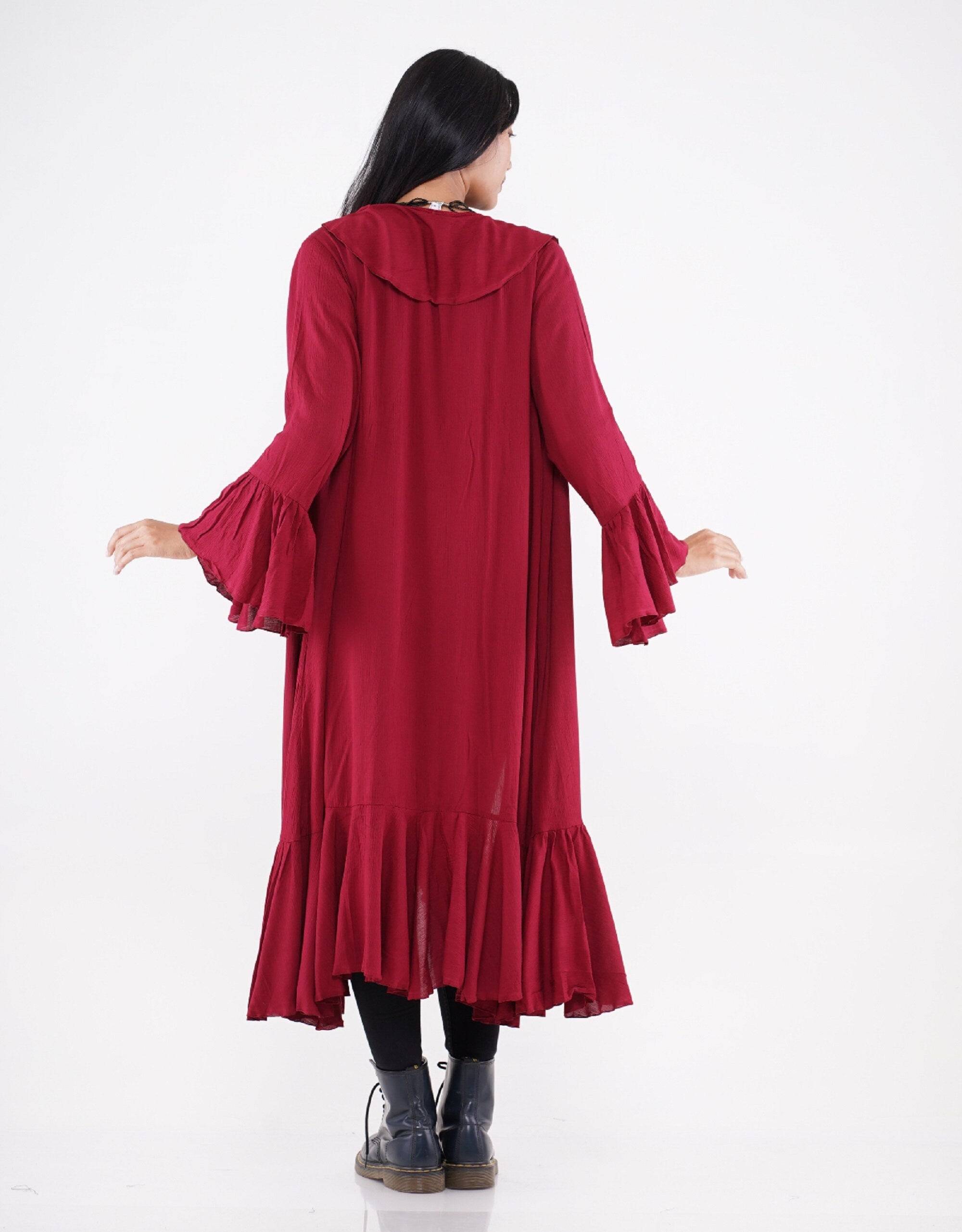 Back view of a red kimono-style wrap dress with ruffle trim and flared sleeves, showcasing its elegant drape.