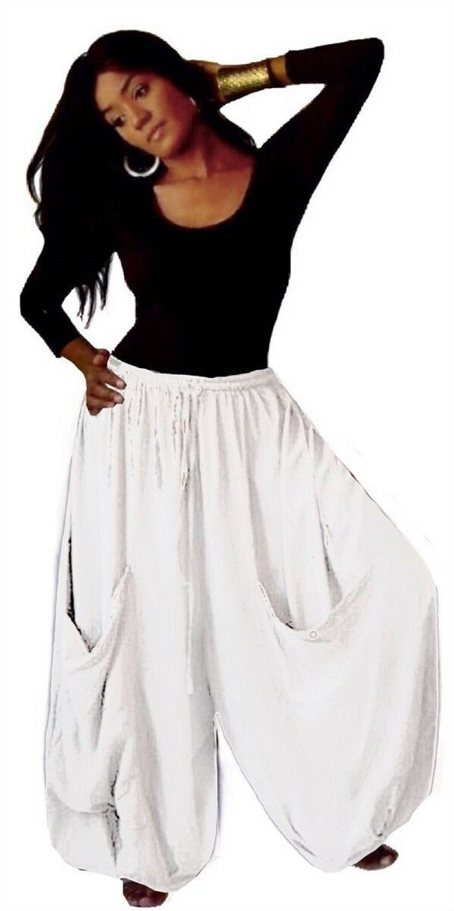 White elastic waist wide-leg gauchos pants with drawstring and big pockets, offering a fresh and airy look for casual wear.