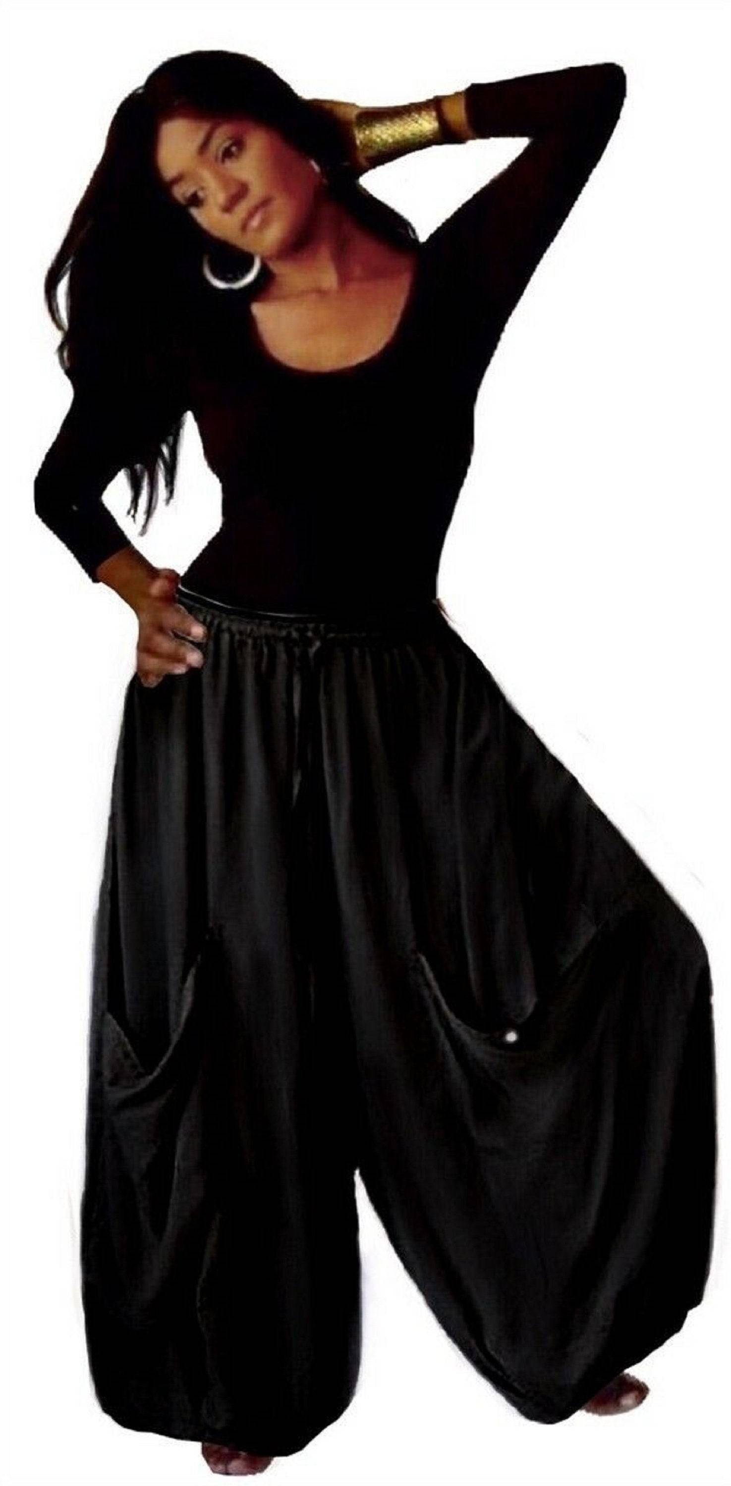 Black wide-leg gauchos pants with an elastic waist, drawstring, and big pockets, a classic and versatile wardrobe essential for women.