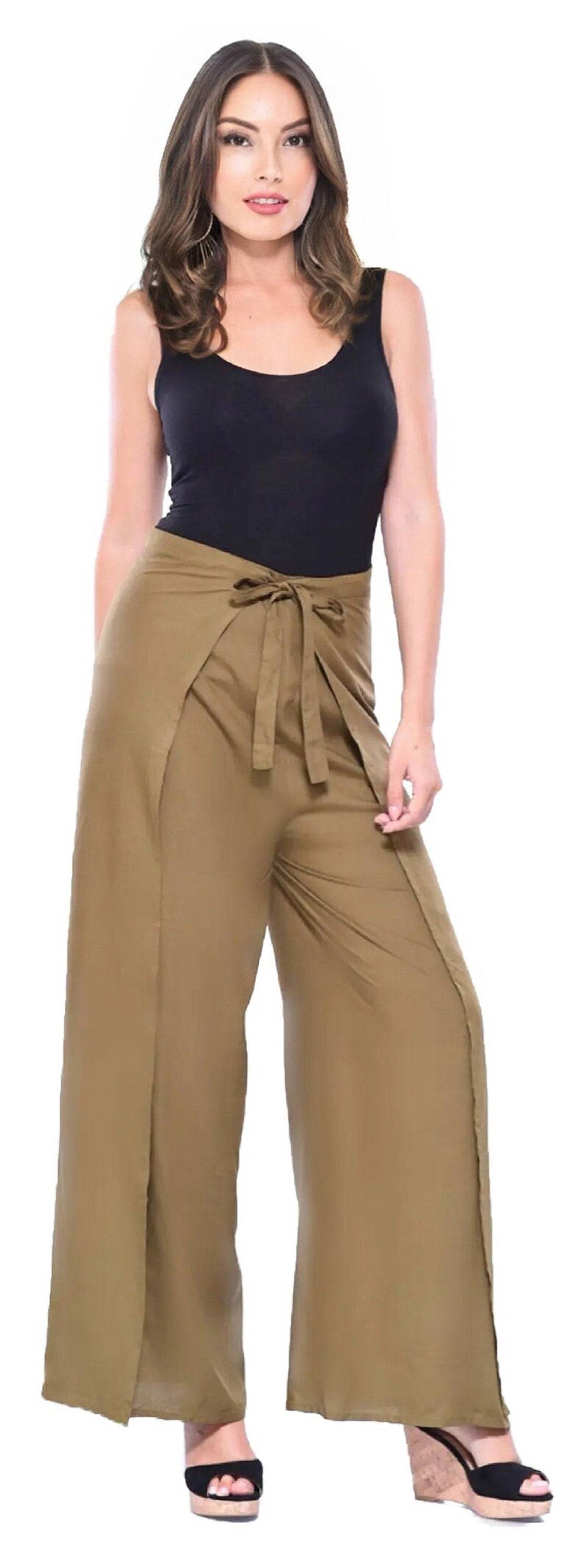 Olive green wrap tie palazzo pants with a wide-leg design, tied at the waist, styled with a black tank top and wedge sandals.
