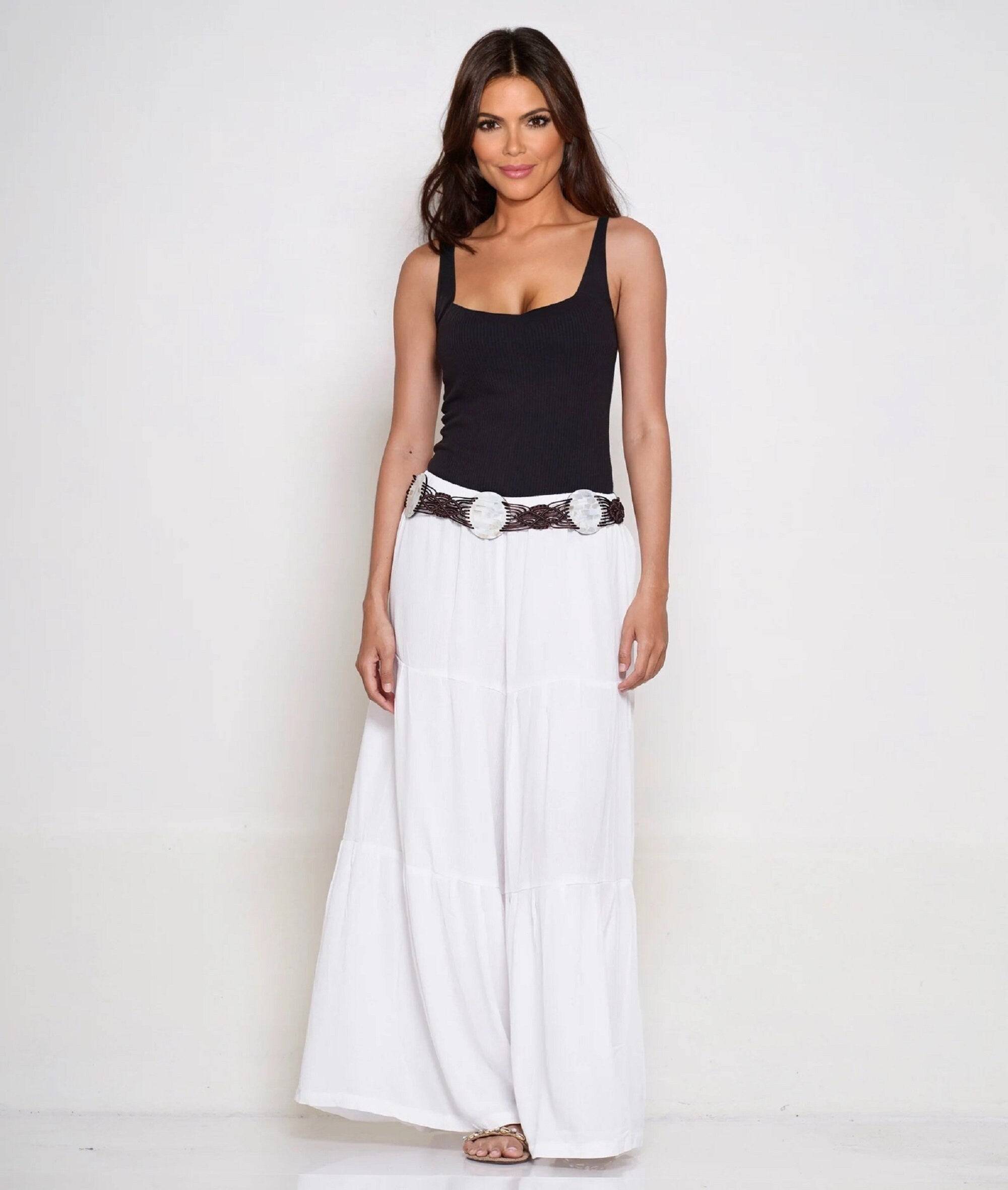 Front view of white gauchos wide-leg ruffled pants with an elastic waist and drawstring ties. Perfect for casual and elegant looks.