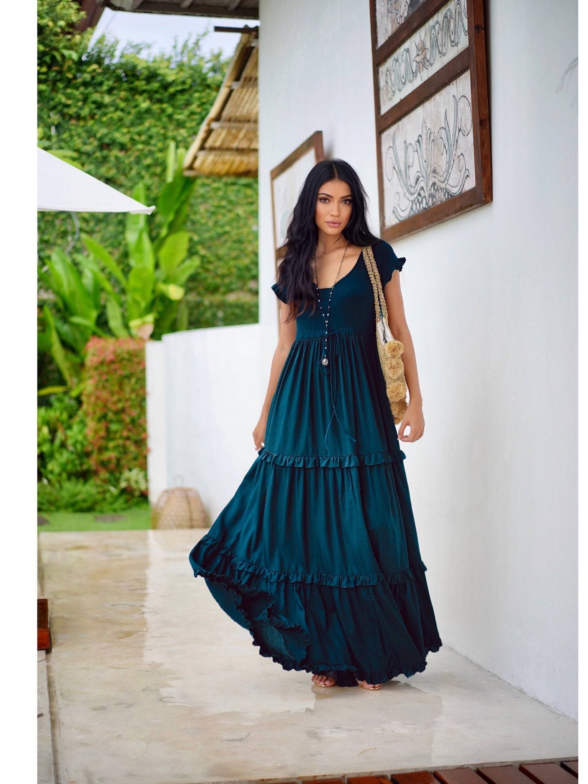 Boho-style gypsy tiered summer maxi dress in rich teal, featuring a stretch bodice and ruffled details, designed for comfort and elegance.