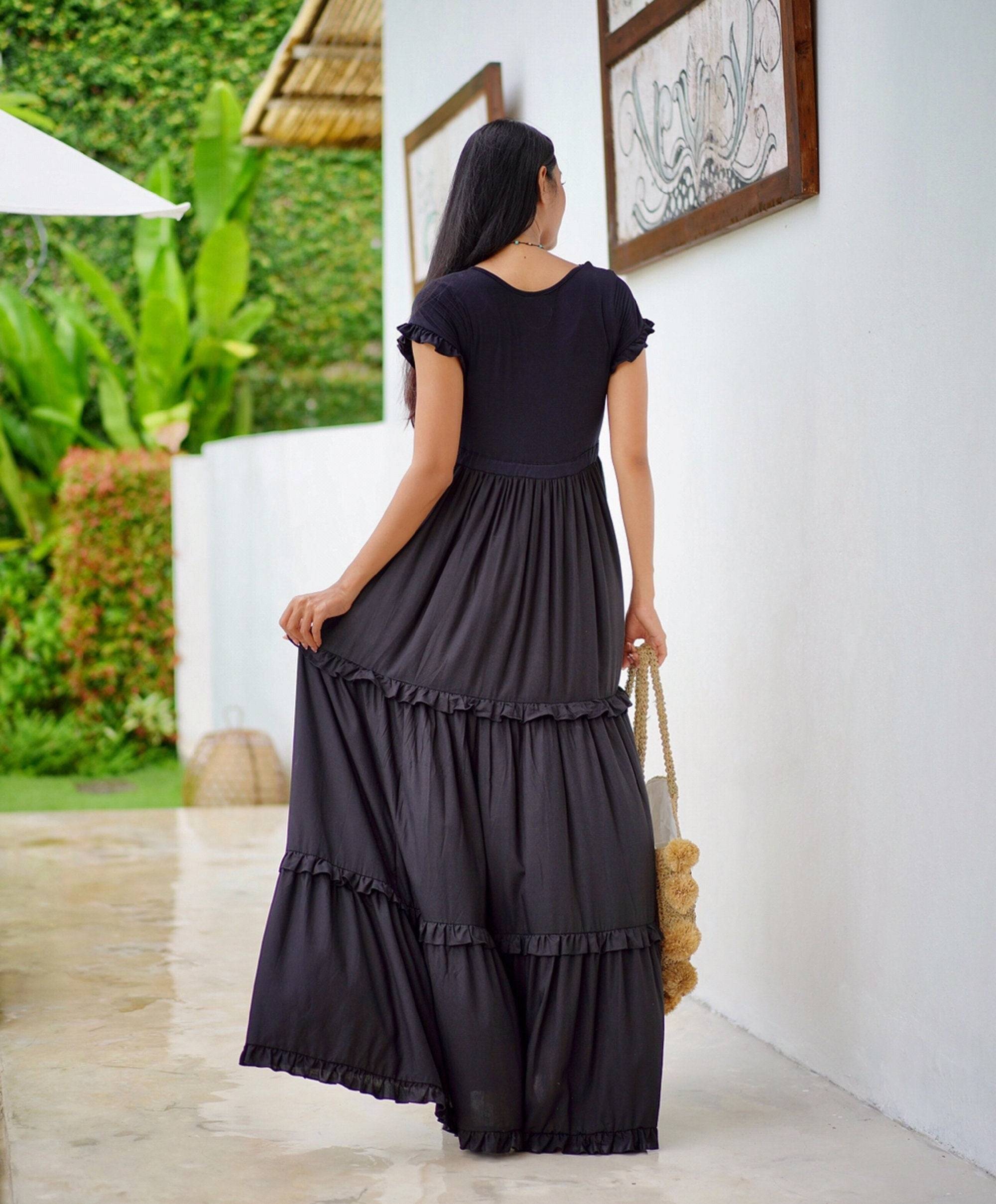 Back view of black gypsy tiered summer maxi dress, showcasing the flowing ruffled design and stretch bodice for a flattering silhouette.