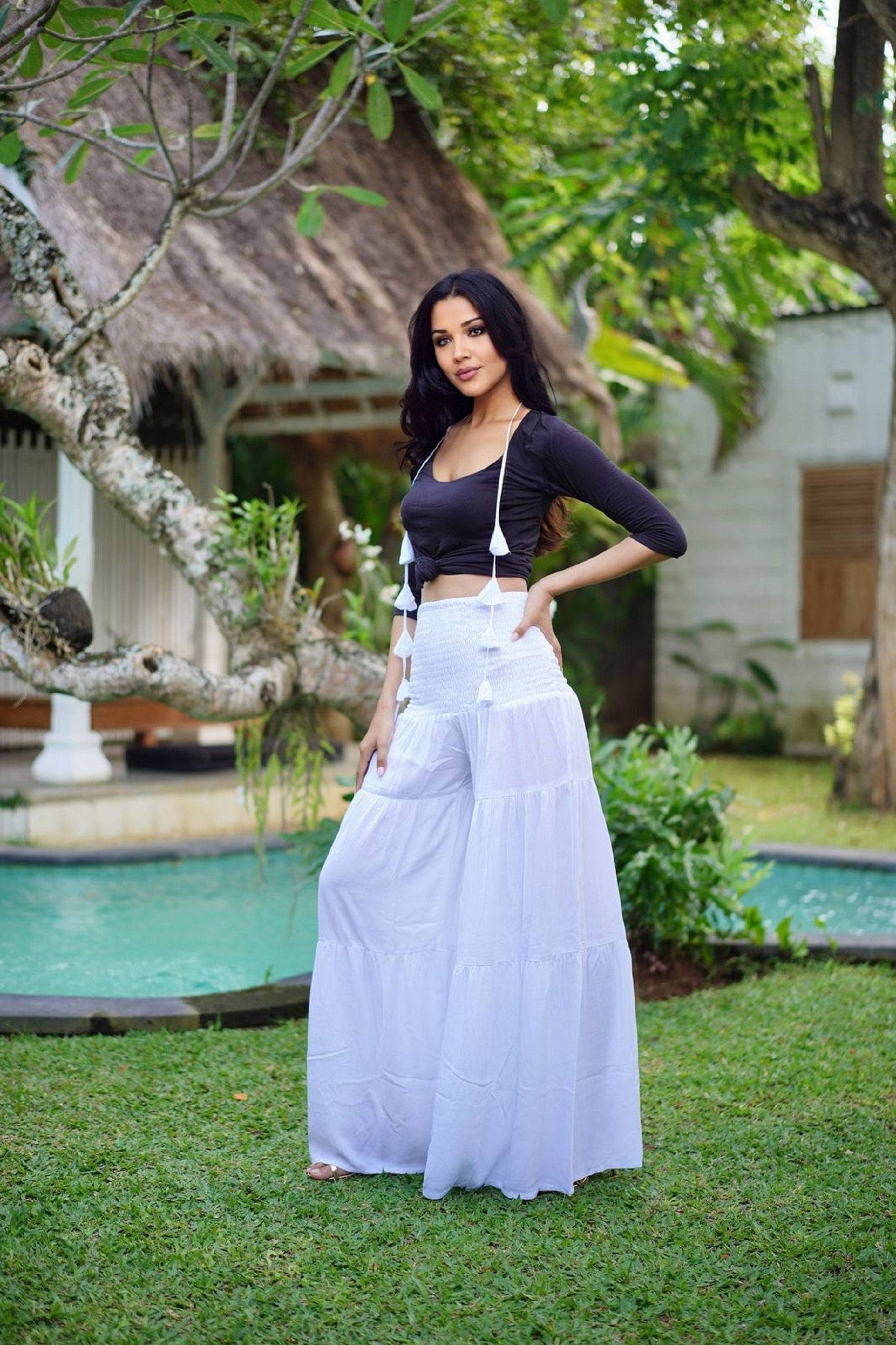 Elegant white smocked waist ruffled palazzo pants with wide leg, perfect for all sizes from S-5X. A stylish and breathable choice for any occasion.