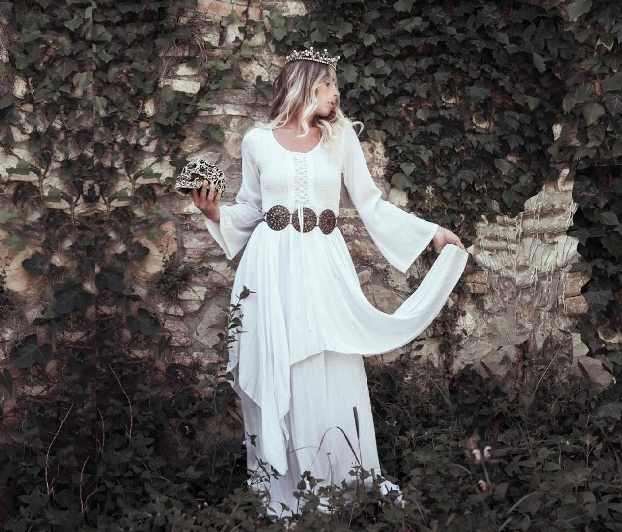 Romantic white Renaissance maxi dress with smocked details and flowing layers, ideal for medieval, boho, or fantasy-themed occasions.