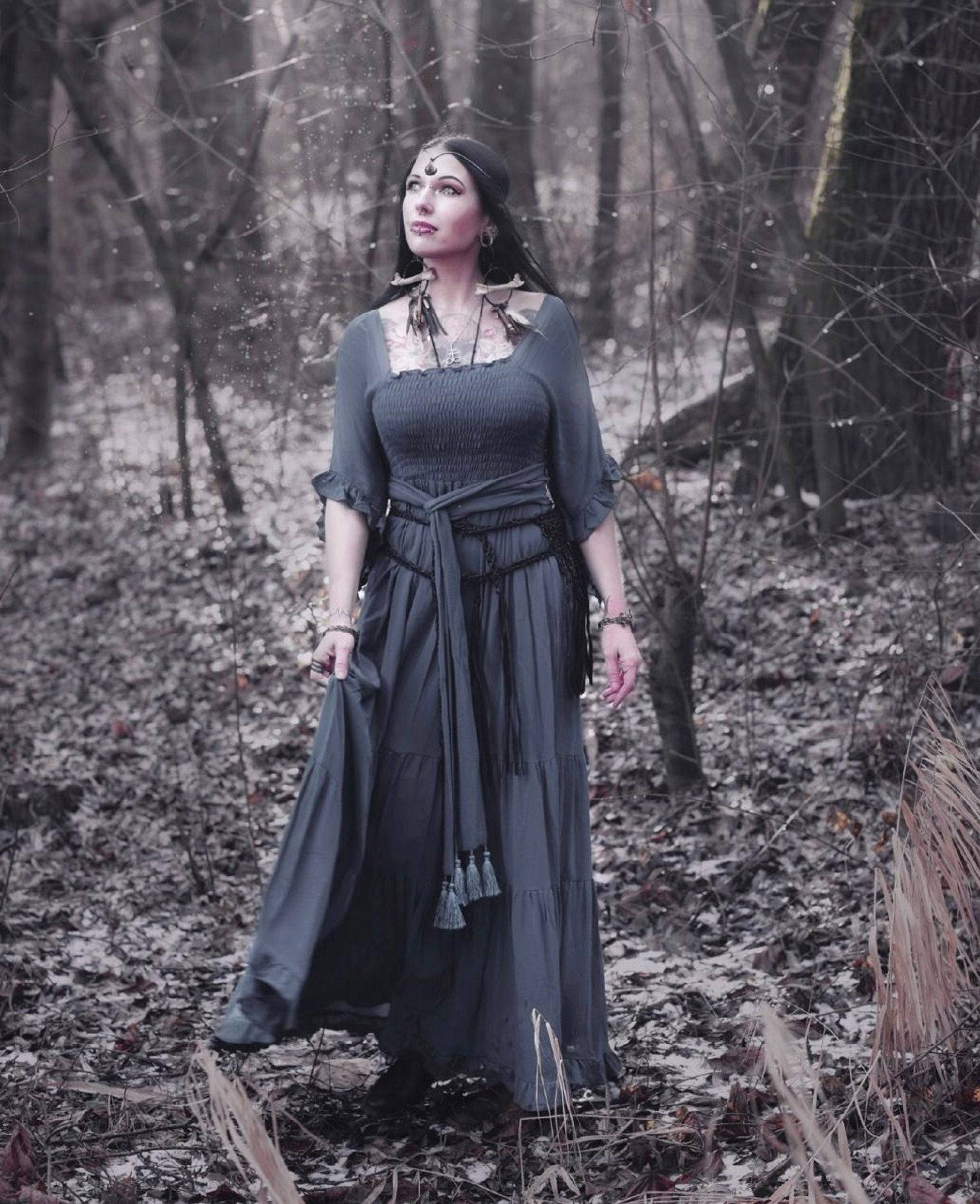 Monochrome medieval vintage maxi dress with an elasticized empire waist and tassel belt, set in an enchanted forest. A timeless and elegant boho outfit.