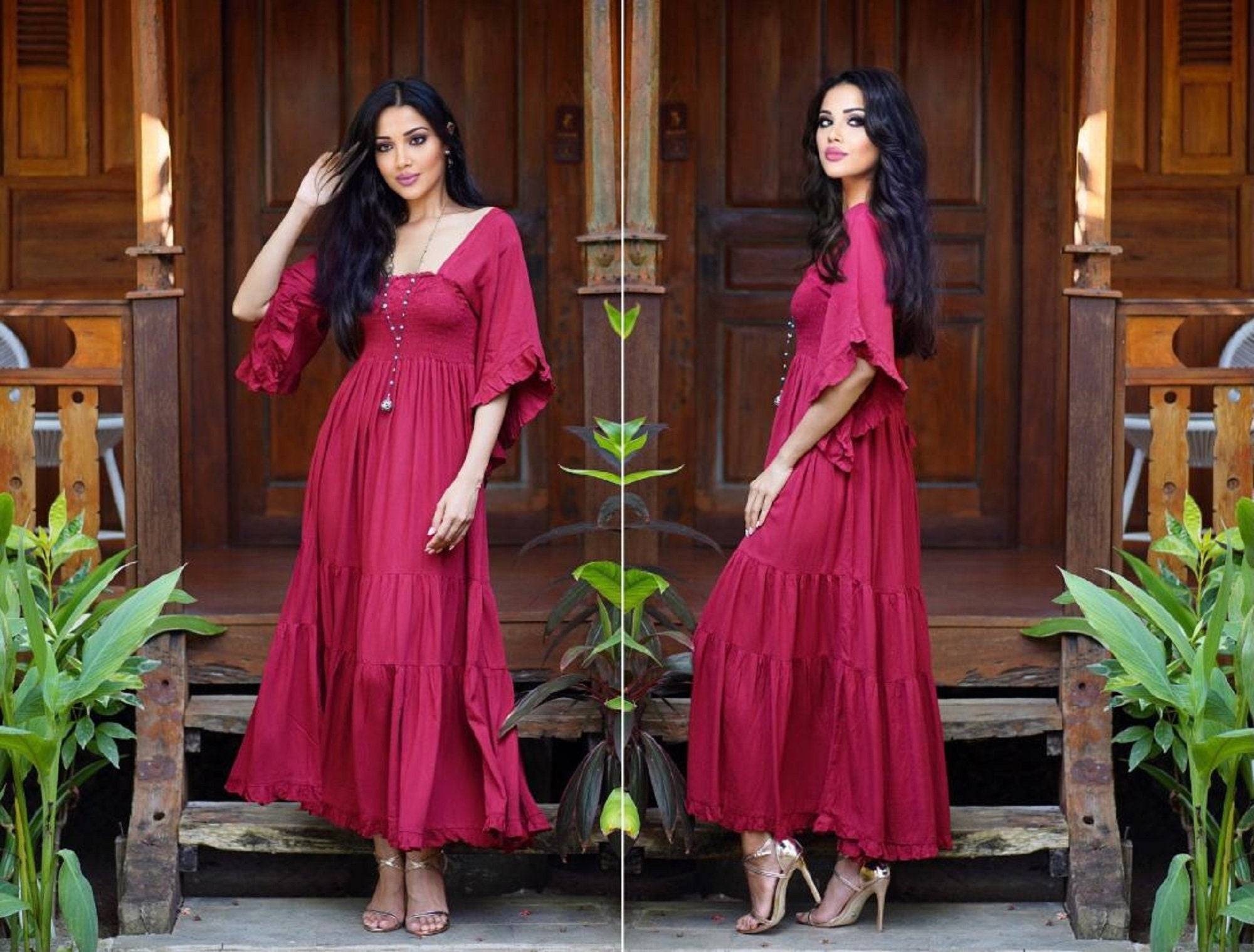 Medieval vintage maxi dress in deep red with an elasticized empire waist and tassel belt, perfect for all sizes. Boho-inspired design with flowing sleeves.