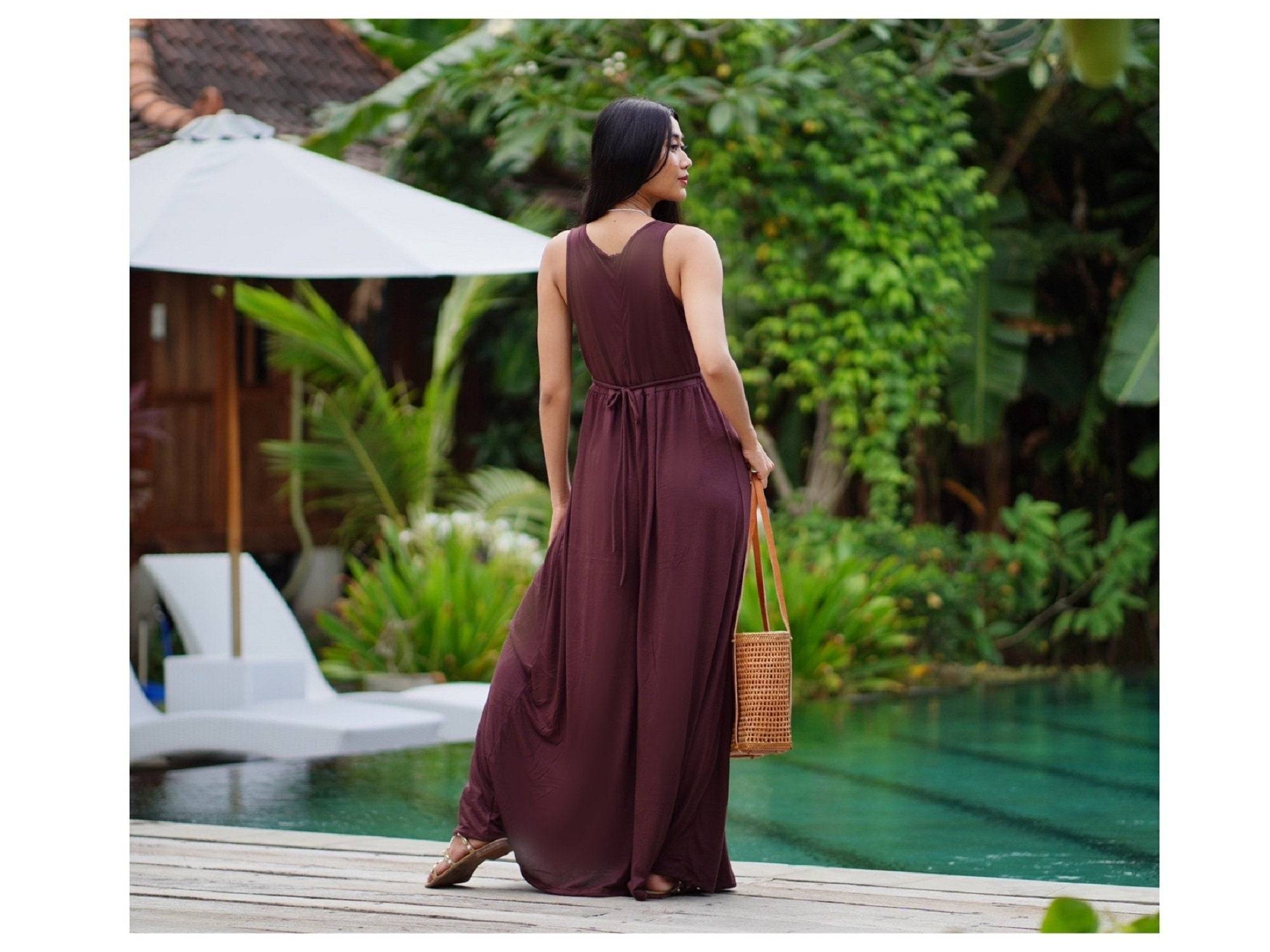 Back view of brown stretchable jersey jumpsuit featuring a tie-back design and wide palazzo legs. Stylish and comfortable for all sizes S-5X.