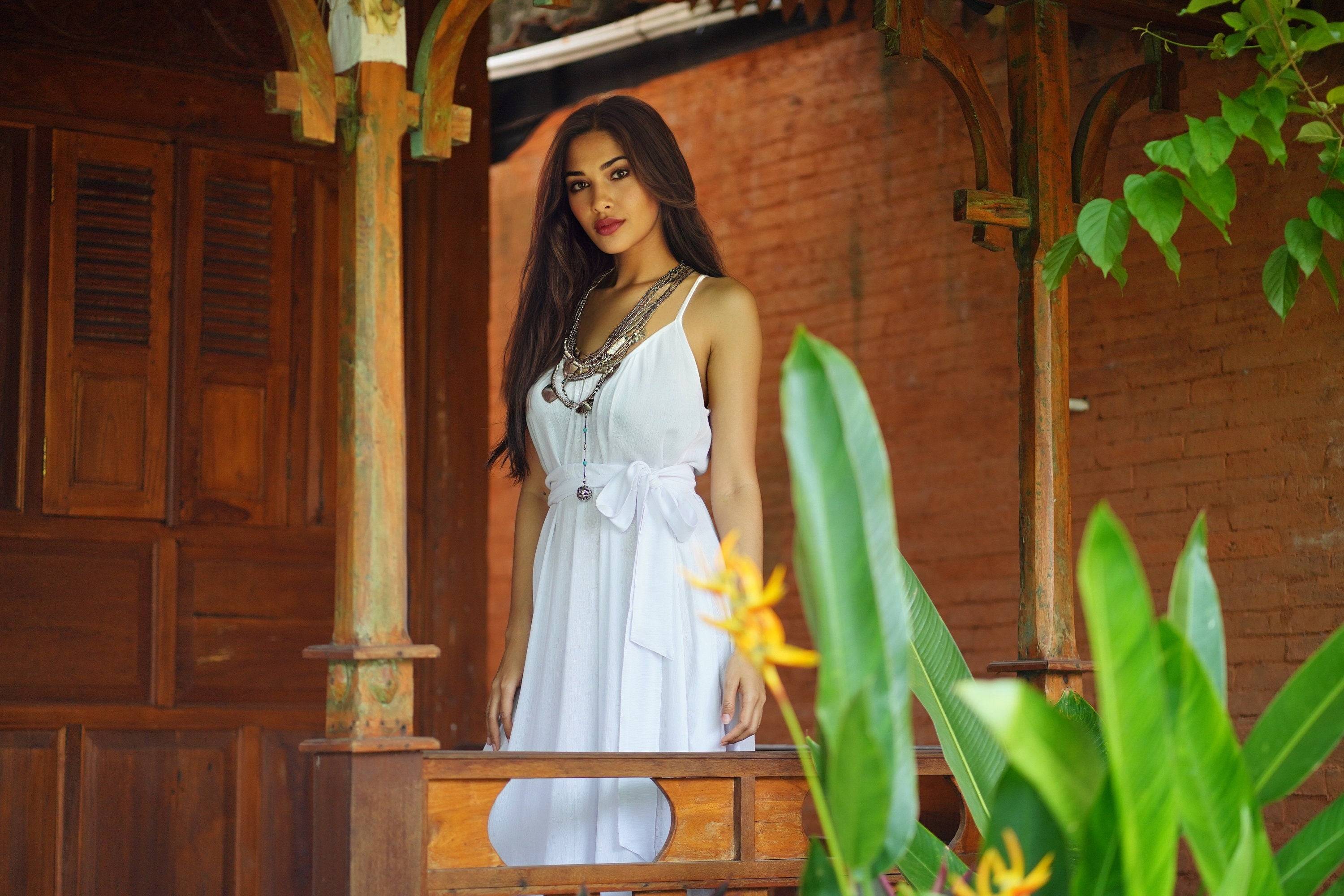 Charming white Renaissance maxi dress with a belted waist and pockets. A versatile sundress perfect for casual and elegant occasions.