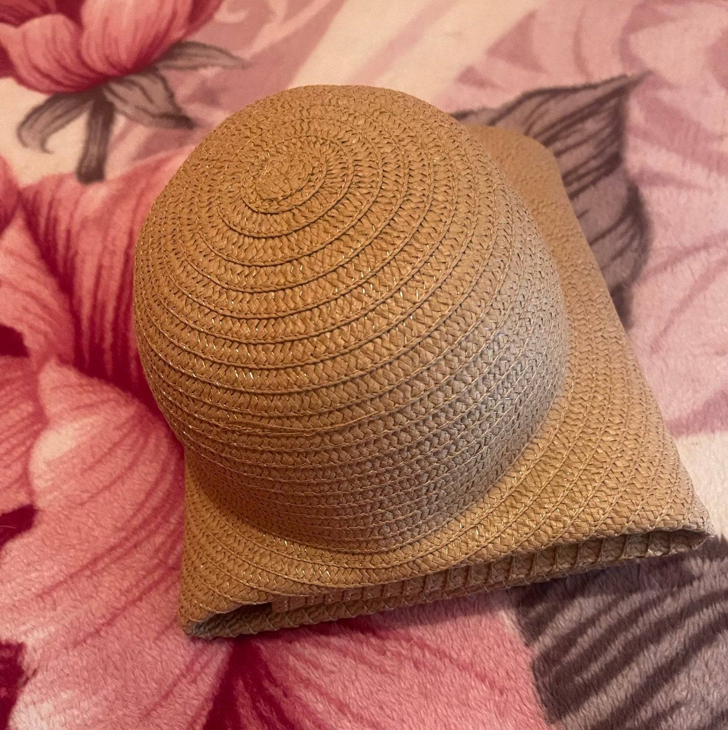 Foldable beige oversized 27-inch wide brim sun hat, designed for easy packing and UV protection.