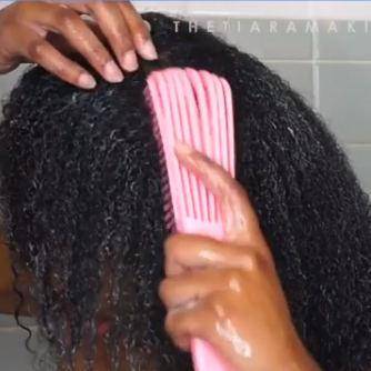 Pink Painless Detangler Brush in use on wet 4C hair, demonstrating easy detangling and reduced breakage for natural hair care routines.