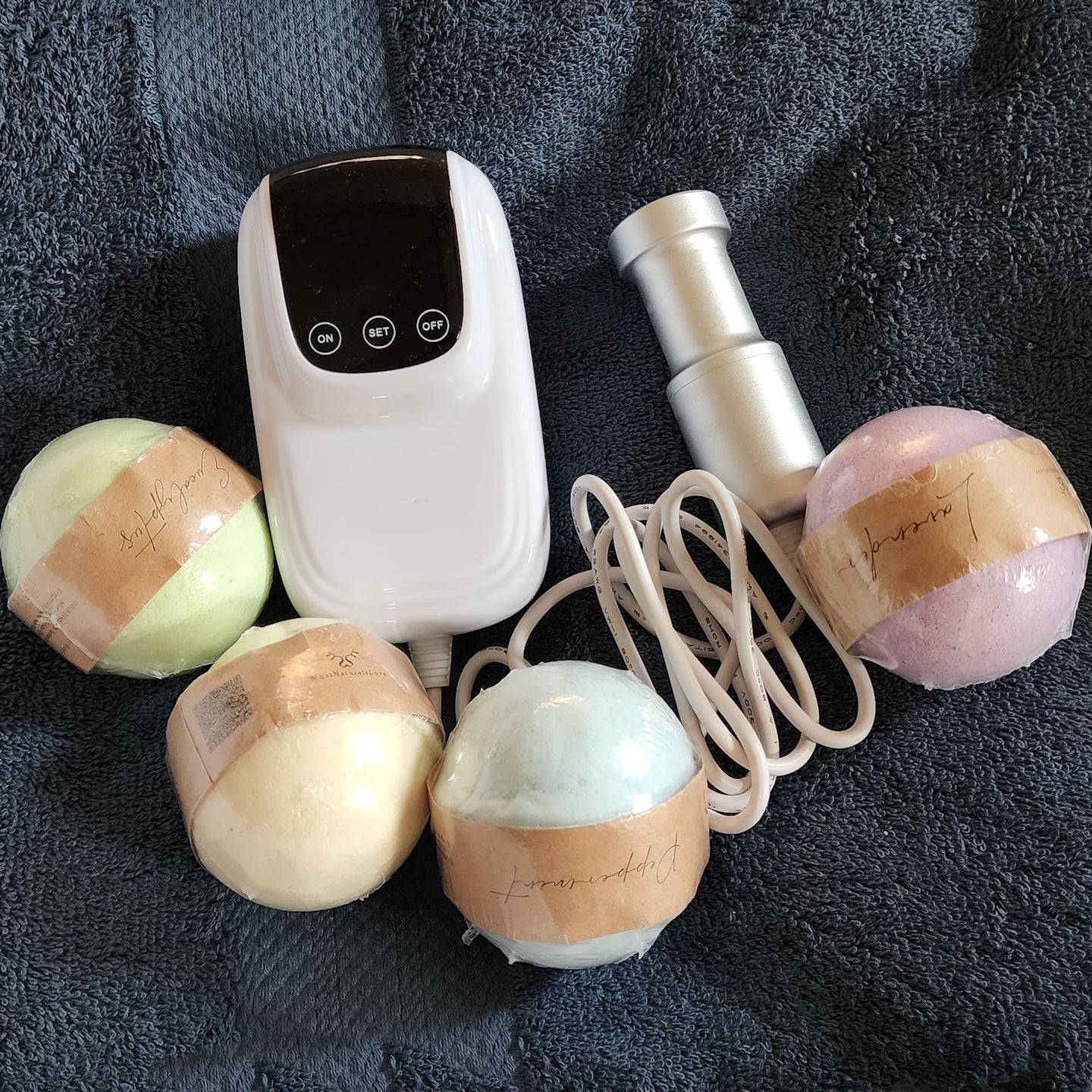 Sonic Loc Detox Rod with bath bombs, enhancing the deep cleansing experience for dreadlocks and locs.