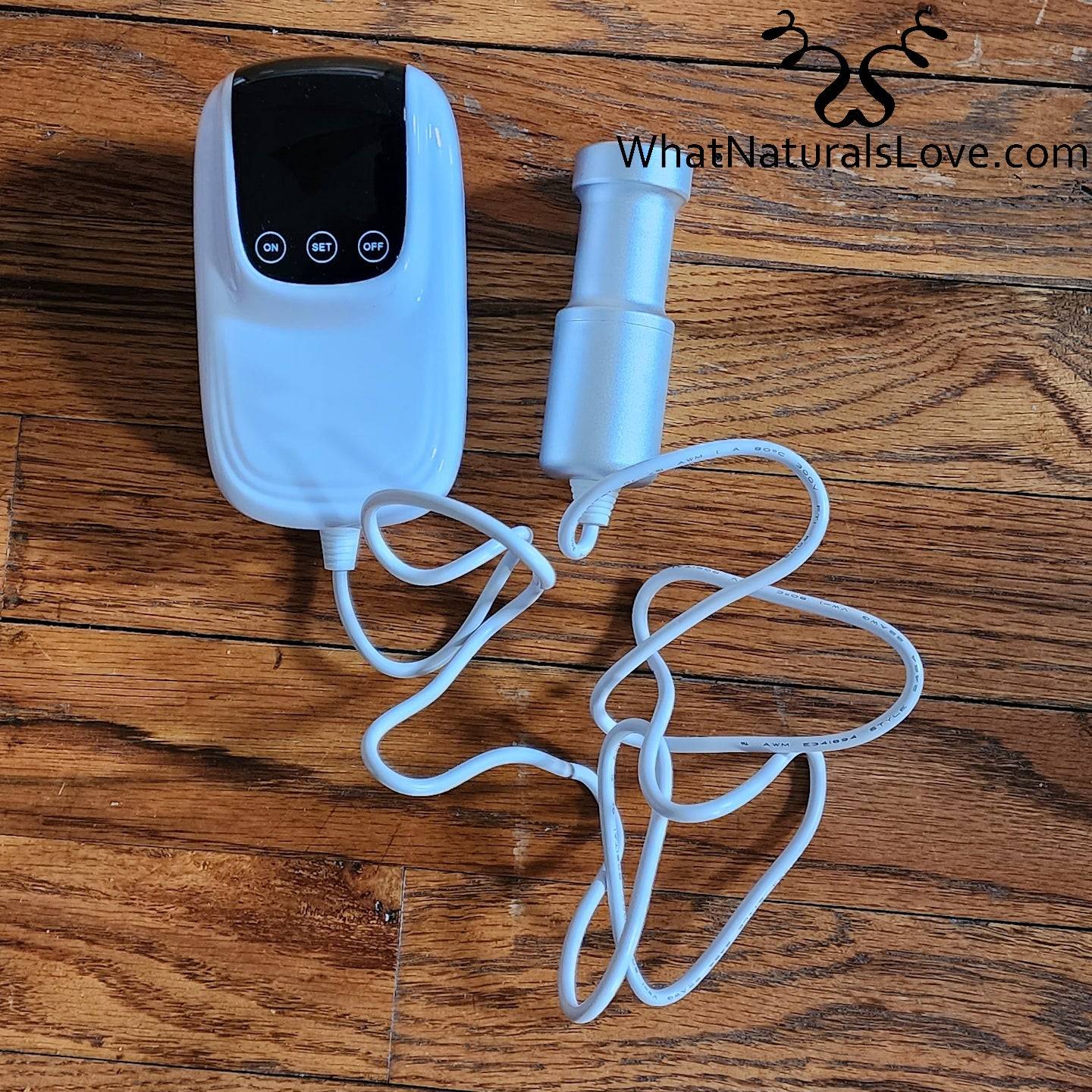 Sonic Loc Detox Rod device on a wooden surface with branding from WhatNaturalsLove.com, ideal for detoxing locs.