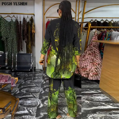 Back view of an African pants set for women, showcasing a long tunic-style top and matching pants with a bold green and black pattern.