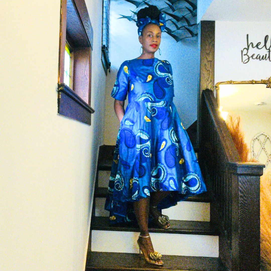 Stylish African high-low dress in blue with intricate patterns and matching headwrap. A perfect blend of tradition and modern fashion.