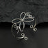 The silver bloom hair cuff standing on a black table
