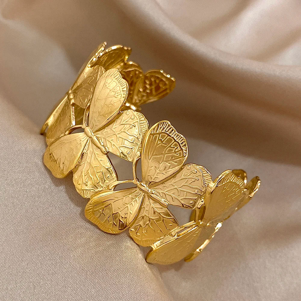 Gold butterfly hair cuff with delicate leaf-textured wings, displayed in close detail.