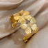 Gold butterfly hair cuff featuring delicate engraved wings, displayed on soft satin.