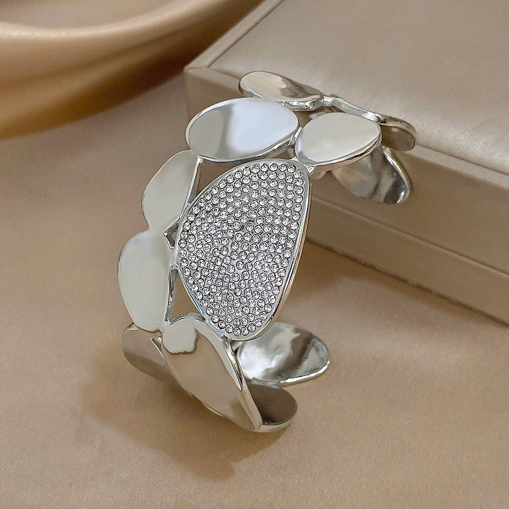 The Silver Crystal Geometric Wide Cuff Bracelet on the side of an box