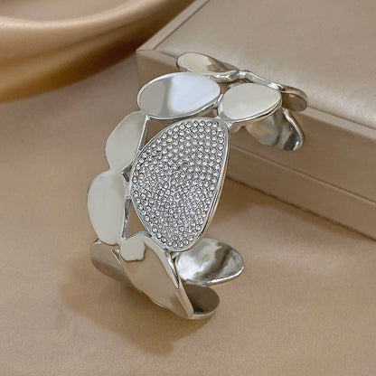 The Silver Crystal Geometric Wide Cuff Bracelet on the side of an box