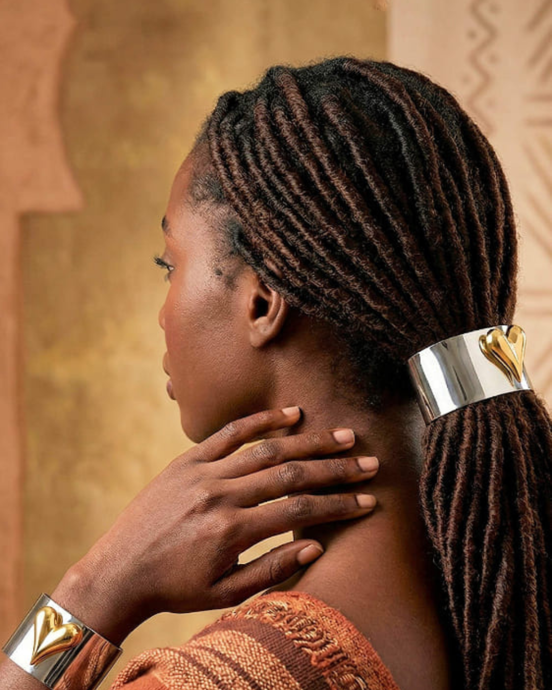 Black woman with locs in a low ponytail held together by the Elegant Heart Hair Cuff to Show your Hair some Love