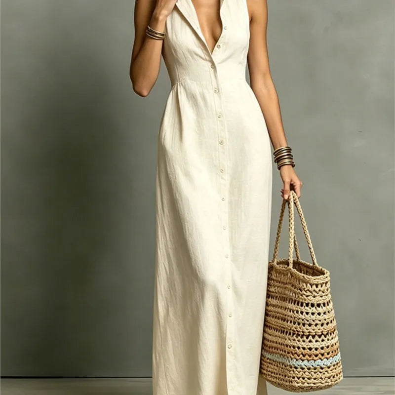 Woman in a white dress holding a woven bag against a gray background