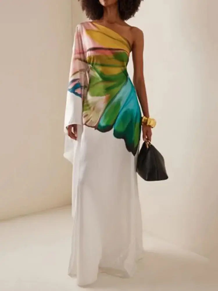 Elegant one-shoulder maxi dress with a vibrant butterfly wing print on a flowing white fabric. Perfect for summer events and stylish occasions.