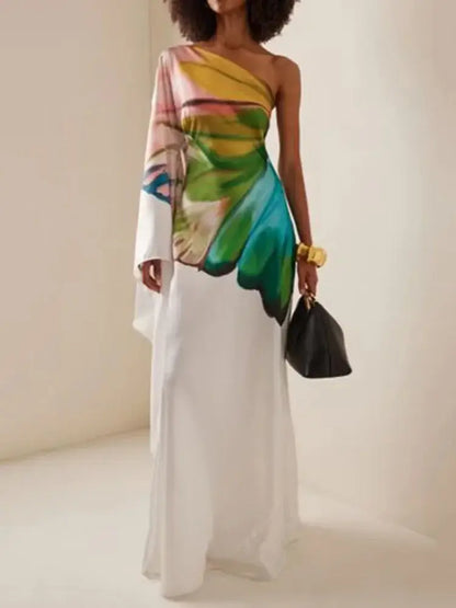 Elegant one-shoulder maxi dress with a vibrant butterfly wing print on a flowing white fabric. Perfect for summer events and stylish occasions.
