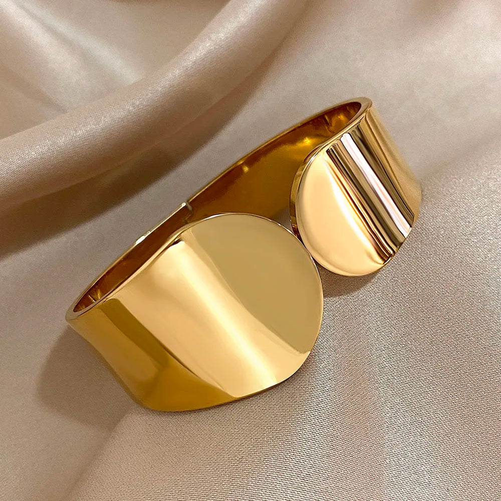 The Fully Gold Geometric Glossy Chunky Cuff Bracelet on an brown background
