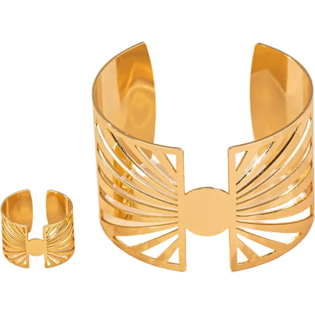 Gold geometric cut-out cuff bracelet and matching ring displayed on a white background, showing clean cutout details