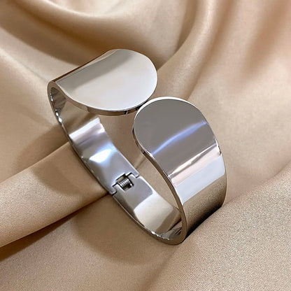 The  Silver Geometric Glossy Chunky Cuff Bracelet  on an brown background