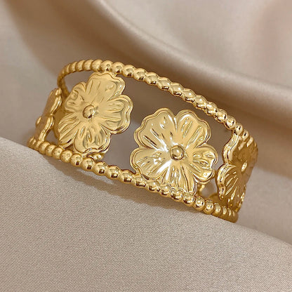 Side angle of Gold Flower Hair Cuff highlighting chunky floral cutout details