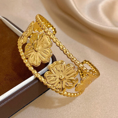 Gold Flower Hair Cuff placed on jewelry box, showcasing floral pattern