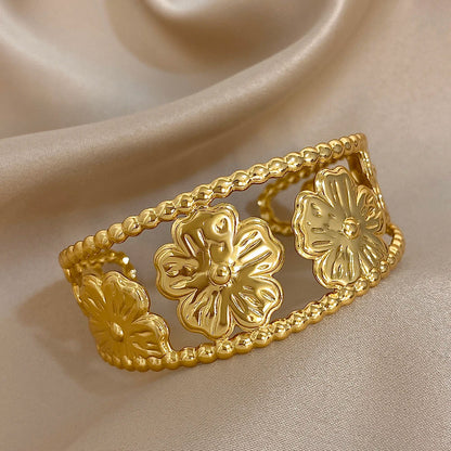 Bold Gold Flower Hair Cuff with open hollow floral design for vintage-inspired looks.