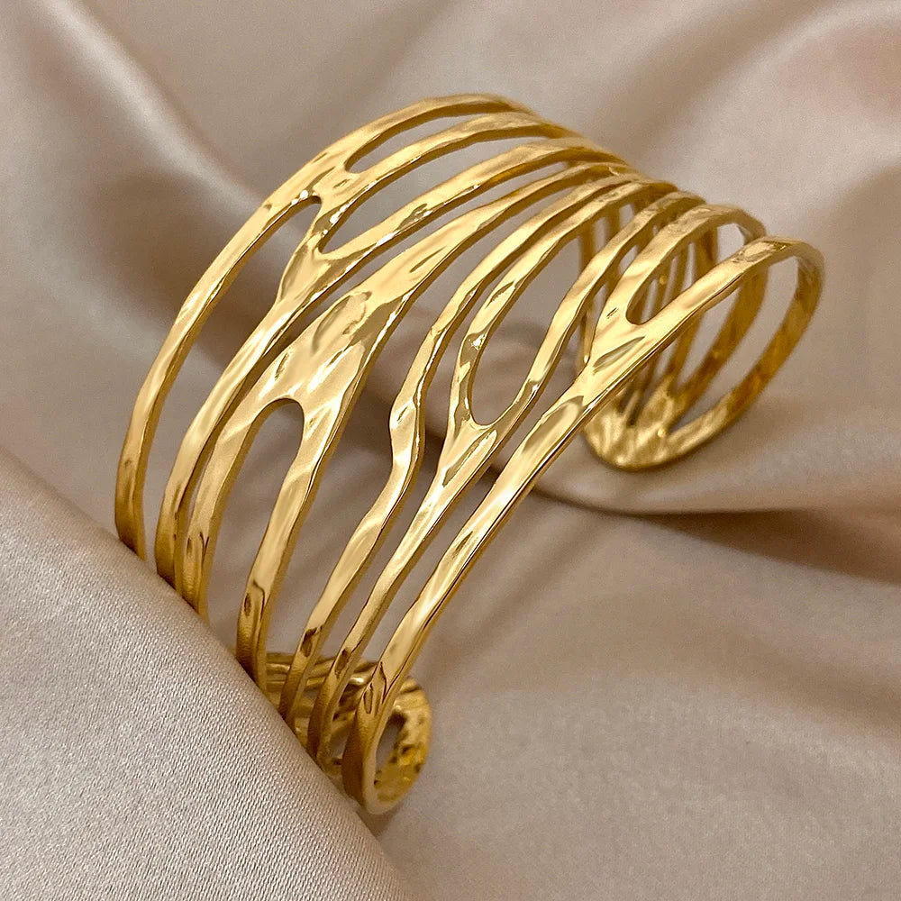 Side angle of Gold Irregular Hair Cuff showing smooth wavy open structure