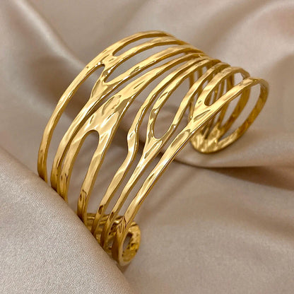 Side angle of Gold Irregular Hair Cuff showing smooth wavy open structure