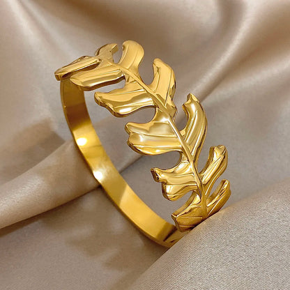 Gold Leaf Hair Cuff with sculpted leaf design and glossy finish, displayed on satin background