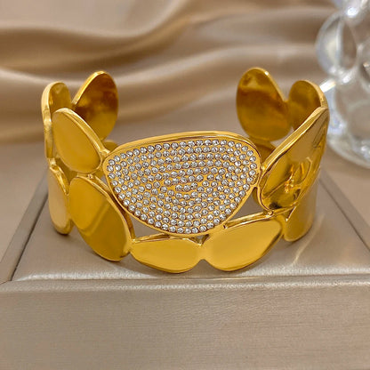 Gold Crystal Geometric Wide Cuff Bracelet on an jewelry pillowcase