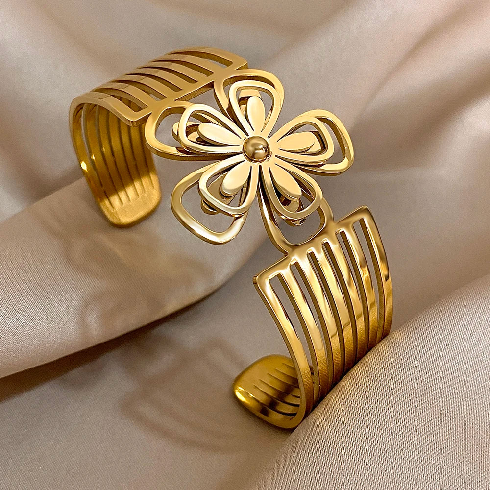 Overhead shot of a gold floral hair cuff with petal cut-out design and linear band structure.