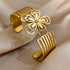Overhead shot of a gold floral hair cuff with petal cut-out design and linear band structure.