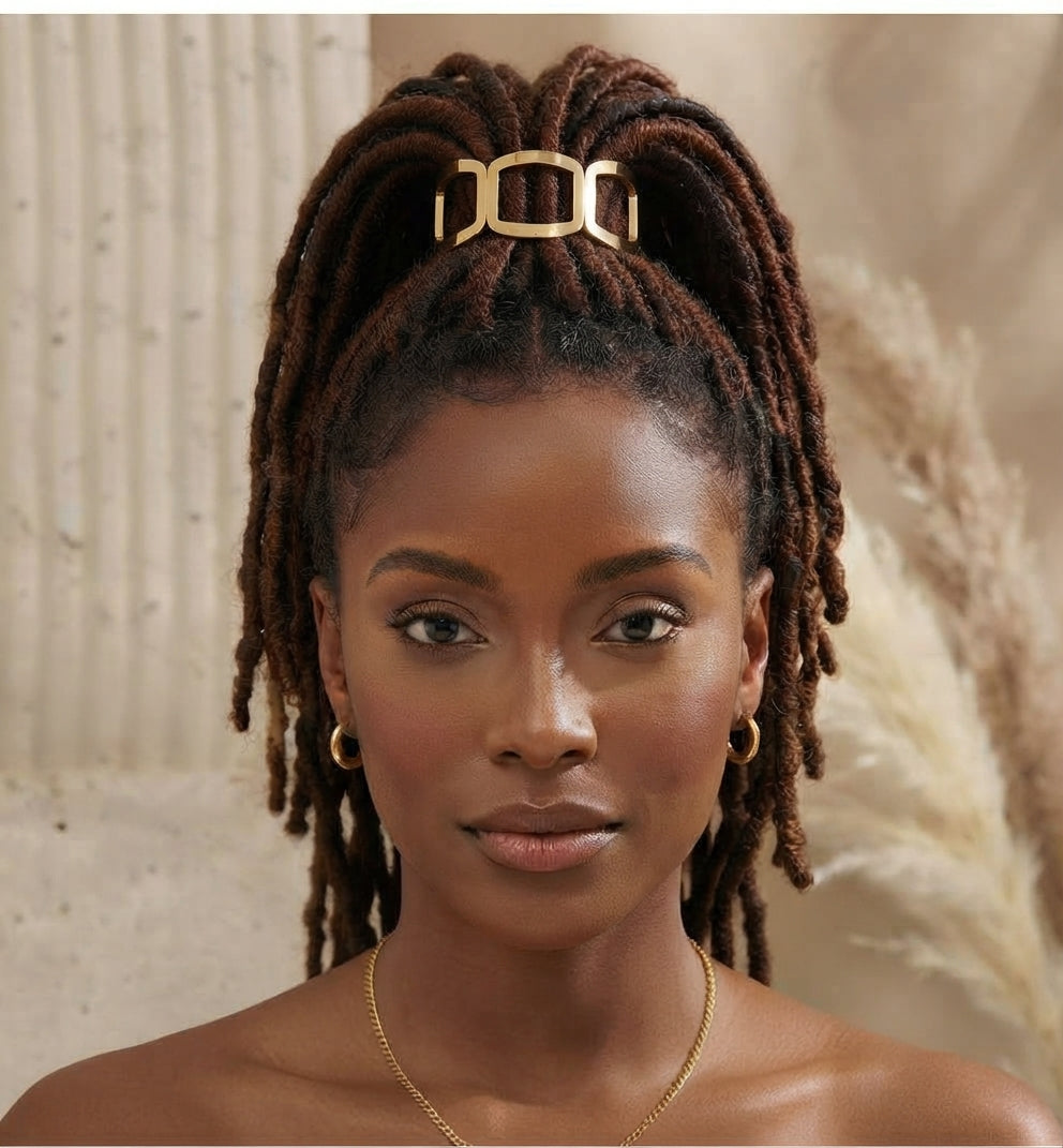Front view of a woman with locs in a high ponytail, secured by a gold open-frame link hair cuff