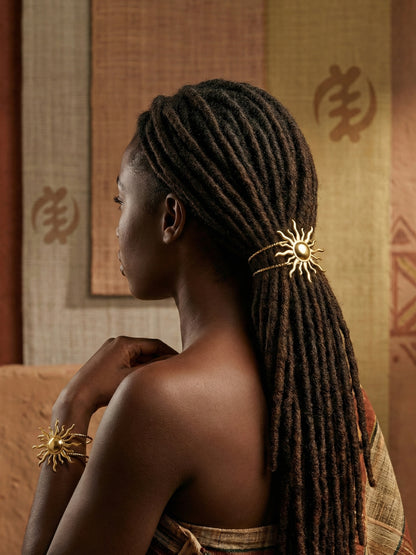 Black_woman_with_locs_in_a_ponytail_held_together_by_the_Gold Spiral Sun Hair Cuff