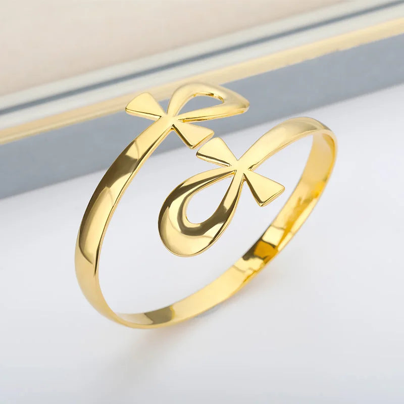 Gold Egyptian Double Circle Ankh Cross Bracelet Bangle in stainless steel, featuring a polished finish and symbolic twin ankh design.