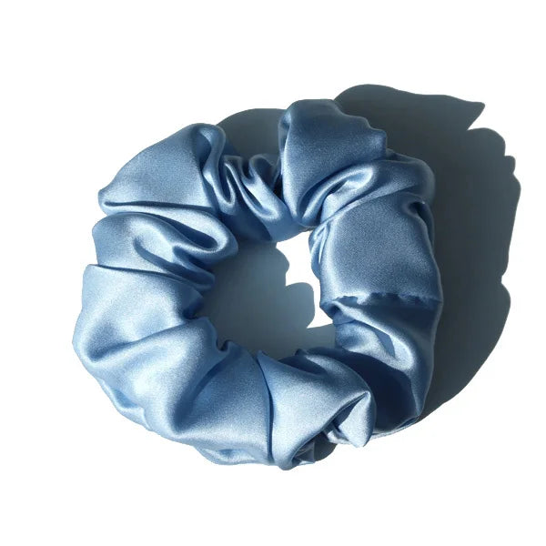 Light pink large mulberry silk scrunchie with a soft, silky texture. Premium silk hair tie designed for smooth, damage-free hair styling.