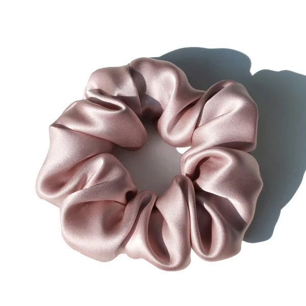 Sky blue large mulberry silk scrunchie with a glossy, smooth finish. Luxurious silk hair tie for a soft and stylish hair hold.